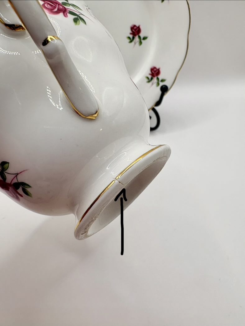 White teacup with floral design on a white background