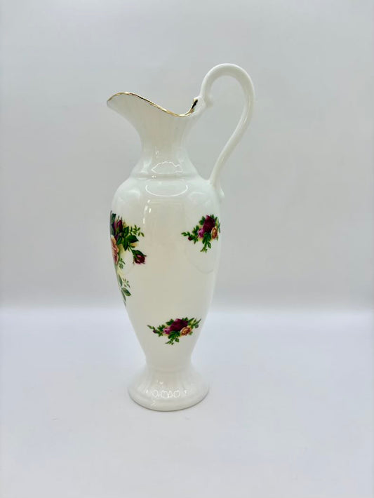 White ceramic pitcher with floral patterns on a white background