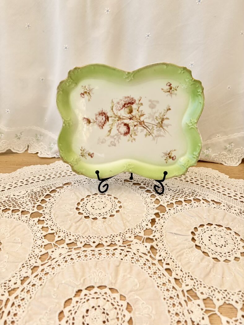 Decorative plate with floral design on a lace doily