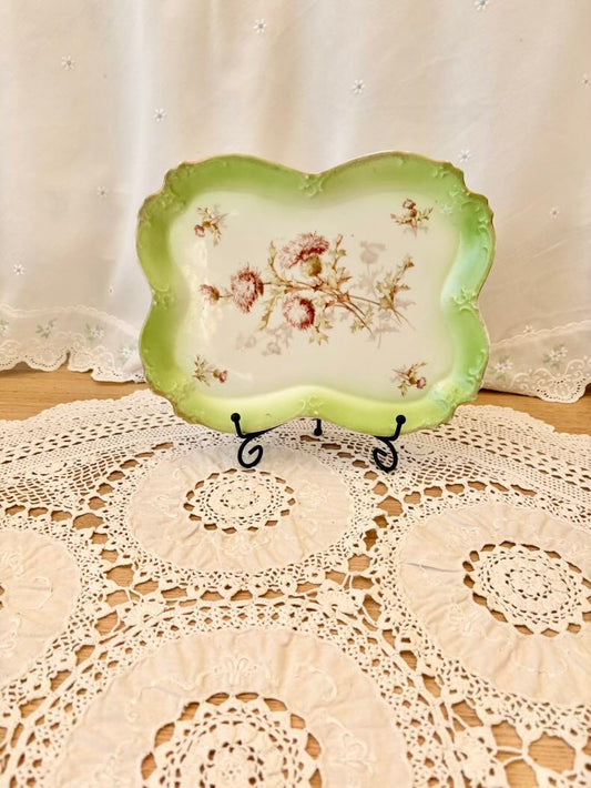 Decorative plate with floral design on a lace doily