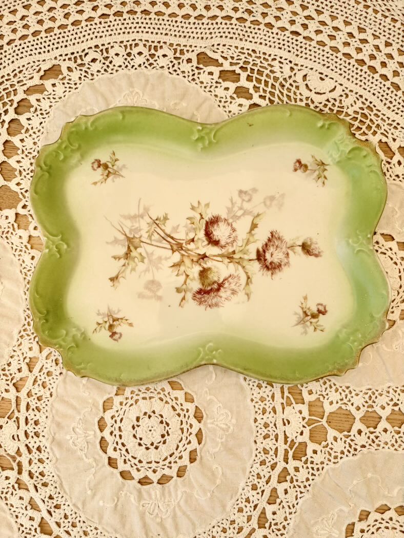 Decorative plate with floral design on a lace background