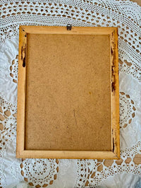 Wooden picture frame on a lace doily