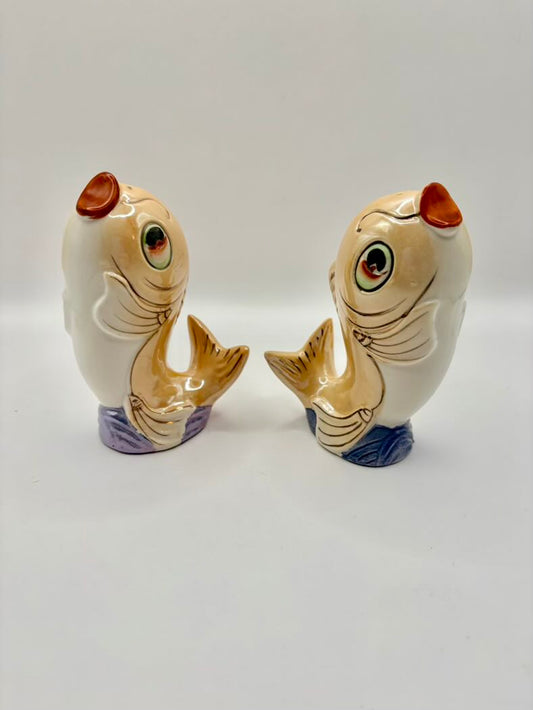 Two ceramic fish-shaped salt and pepper shakers on a white background