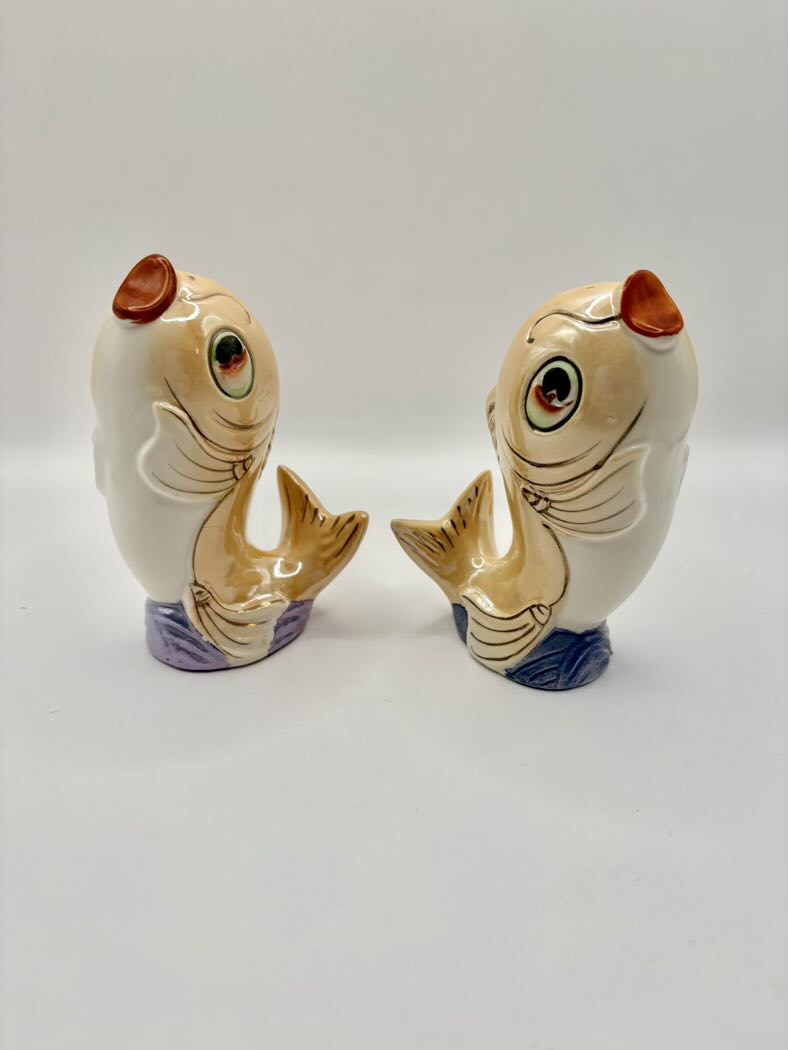 Two ceramic fish-shaped salt and pepper shakers on a white background