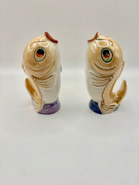 Two ceramic fish-shaped salt and pepper shakers on a white background