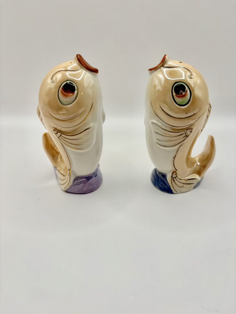 Two ceramic fish-shaped salt and pepper shakers on a white background