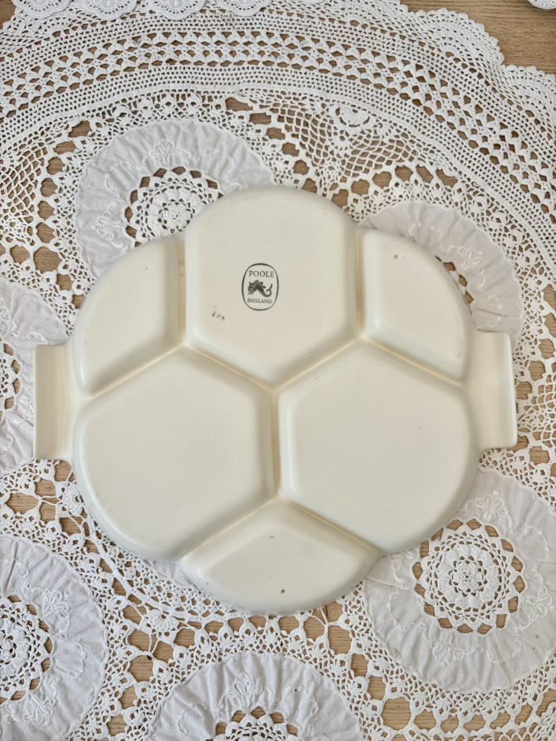White ceramic plate with hexagonal sections on a lace tablecloth