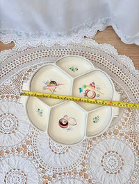 Decorative plate with cartoon designs on a lace doily