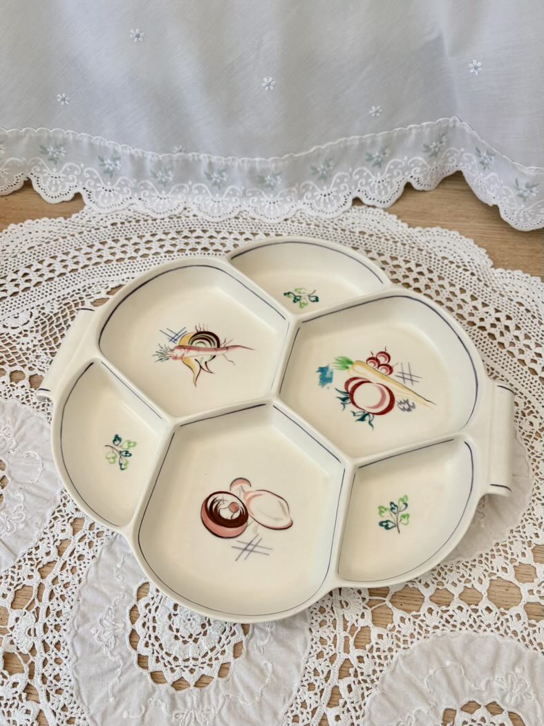 Decorative ceramic plate with floral designs on a lace tablecloth