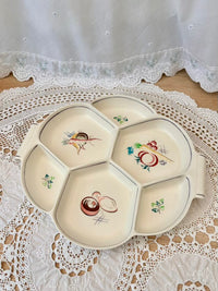 Decorative ceramic plate with floral designs on a lace tablecloth