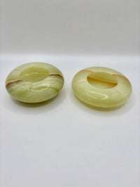 Two green jade rings on a white background