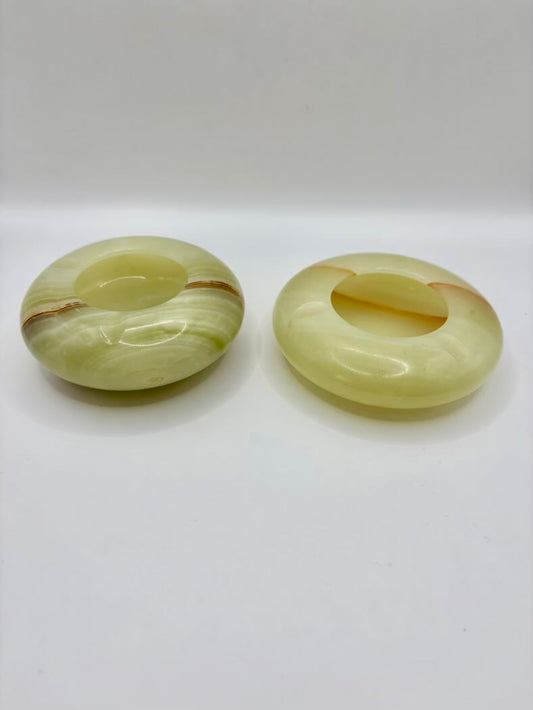 Two green jade rings on a white background
