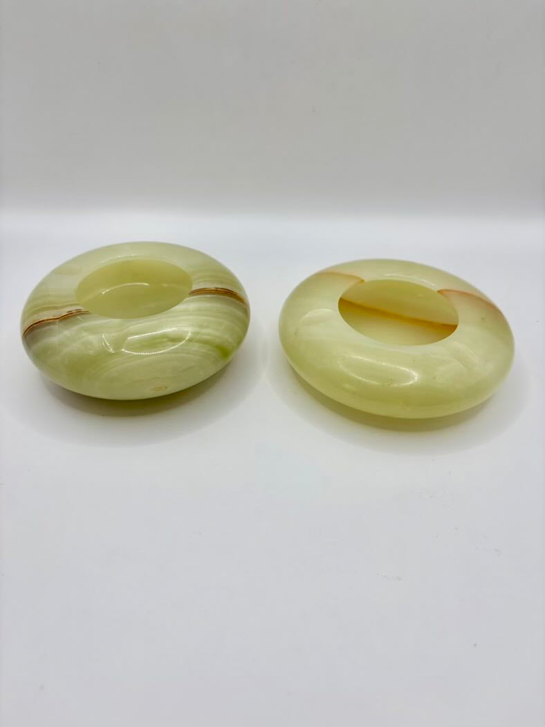 Two green jade rings on a white background