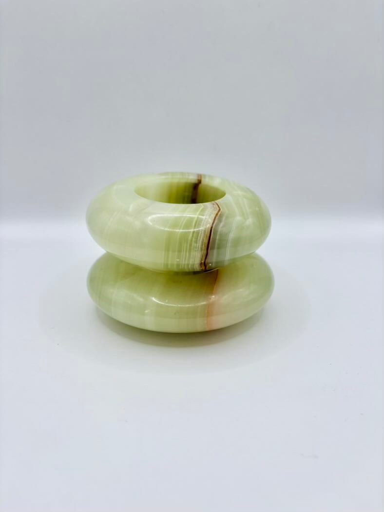 Stack of green stone rings on a white background