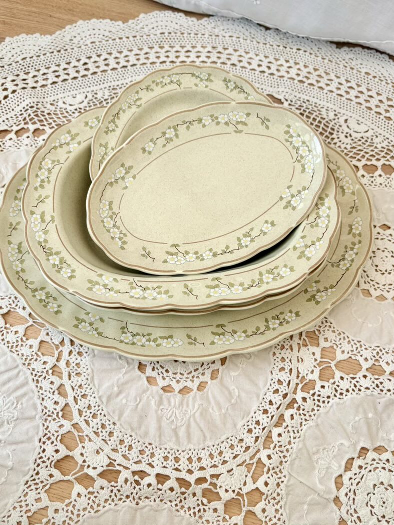 Set of ceramic plates with floral patterns on a lace tablecloth