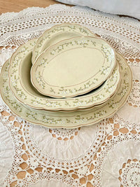 Set of ceramic plates with floral patterns on a lace tablecloth