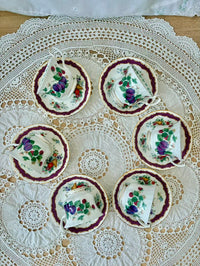 Set of floral teacups and saucers on a lace tablecloth