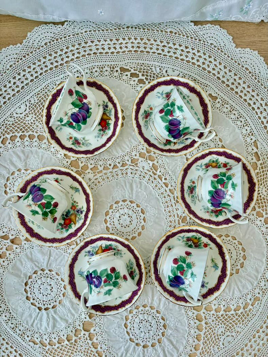 Set of floral teacups and saucers on a lace tablecloth