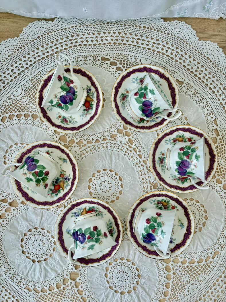 Set of floral teacups and saucers on a lace tablecloth