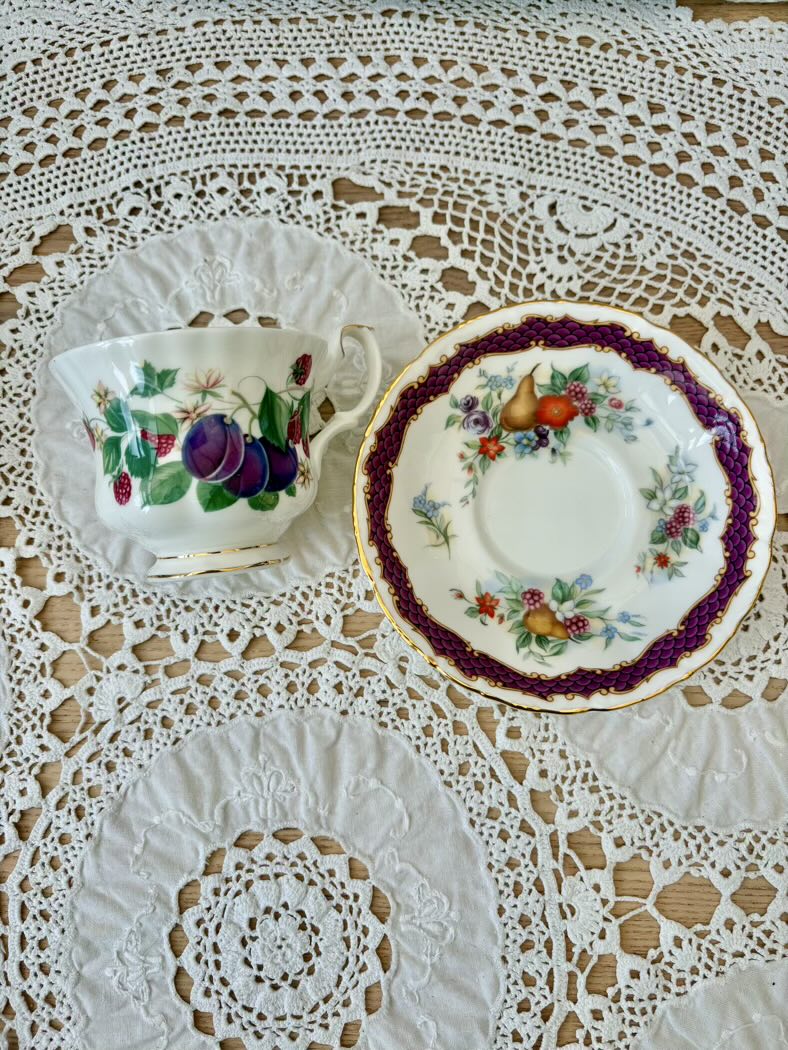 Teacup and saucer with floral design on a lace tablecloth
