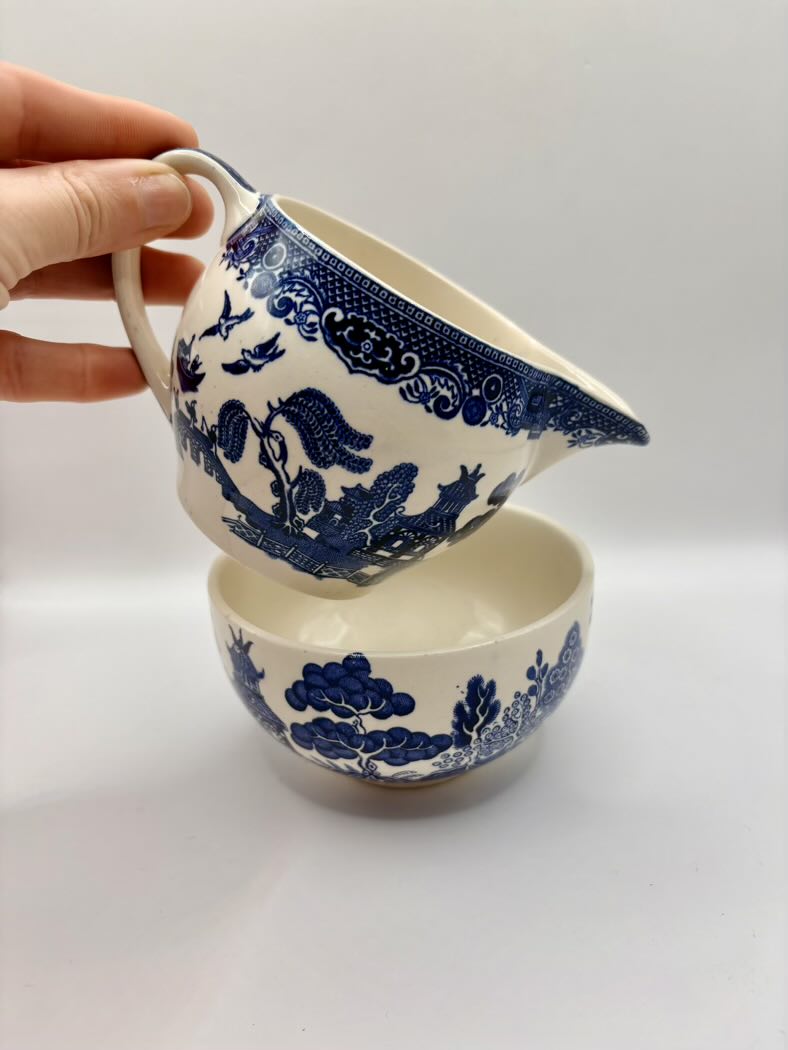 Ceramic bowl and pitcher set with blue floral patterns on a white background