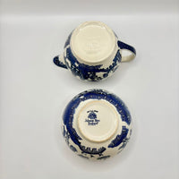 Two blue and white ceramic teacups on a light gray background