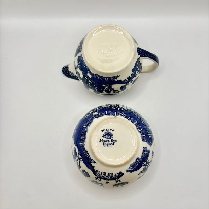 Two blue and white ceramic teacups on a light gray background