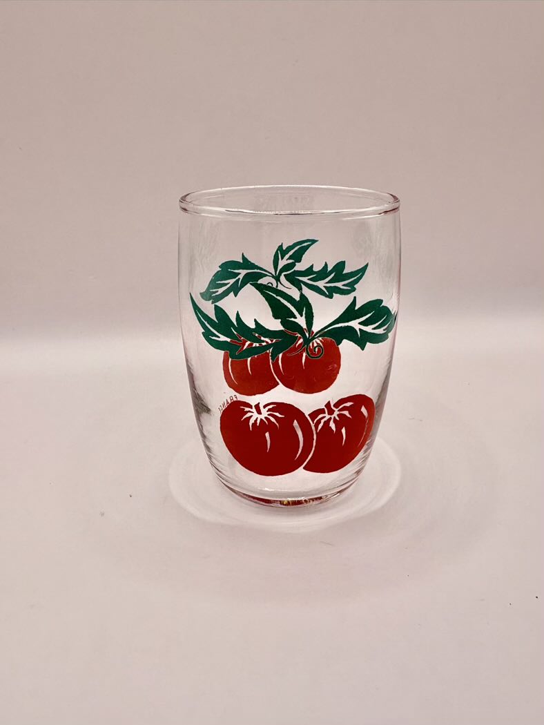 One glass with tomato's drawn on it 
