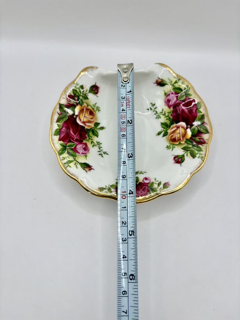 Floral-patterned plate with a measuring tape on a white background