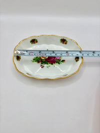 Decorative plate with floral design and gold rim, measured against a white background