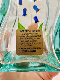 Glass artwork with a gold label on a blurred background