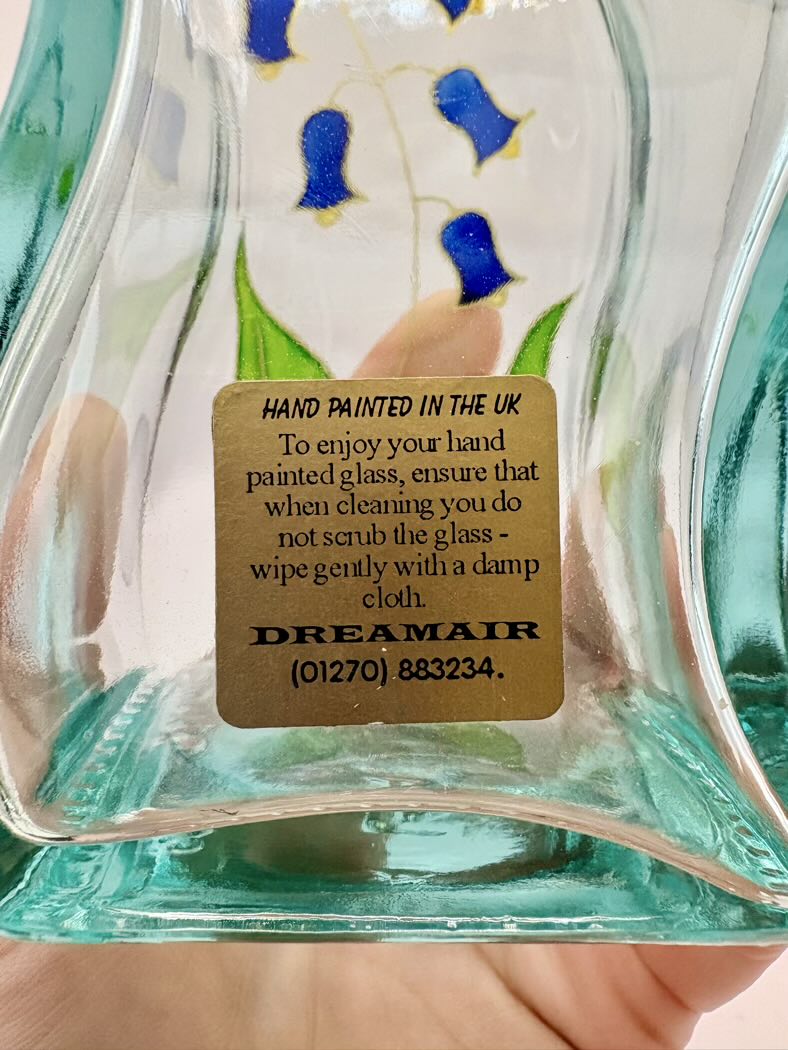 Glass artwork with a gold label on a blurred background