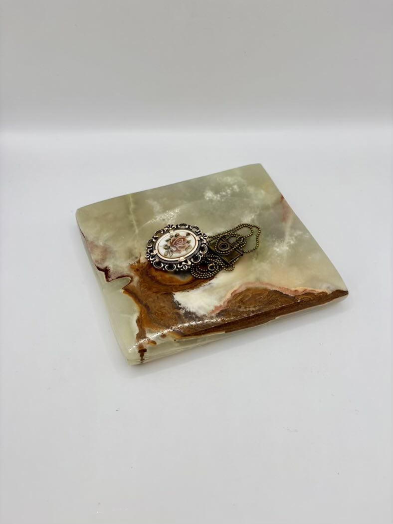 Decorative stone coaster with a decorative ring on a white background