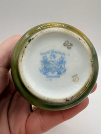 Ceramic jar lid with 'Royal Bayreuth Bavaria' branding held by a hand against a white background