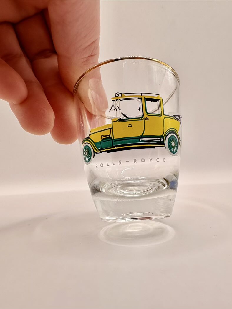 Glass with a Rolls-Royce car design on a plain background