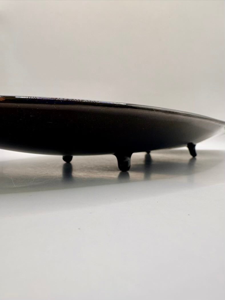 Black ceramic tray on a white surface