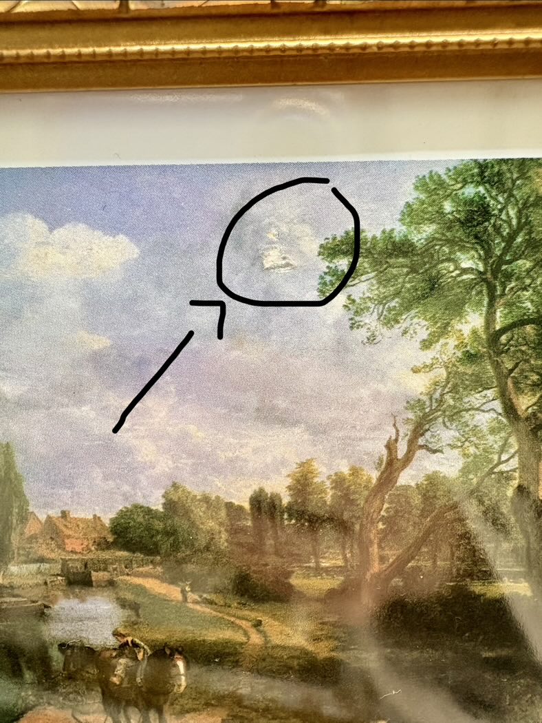 Landscape painting with a person in a boat, framed by a gold border.