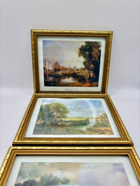 Three framed paintings of landscapes on a white background