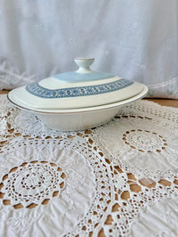 White ceramic dish with blue patterns on a lace tablecloth