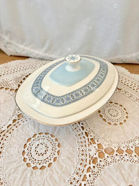 Decorative ceramic dish with a lid on a lace tablecloth