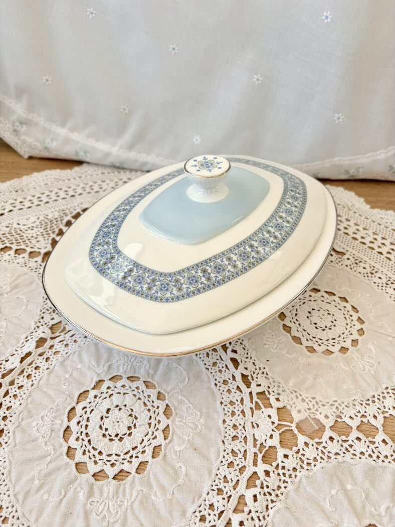 Decorative ceramic dish with a lid on a lace tablecloth