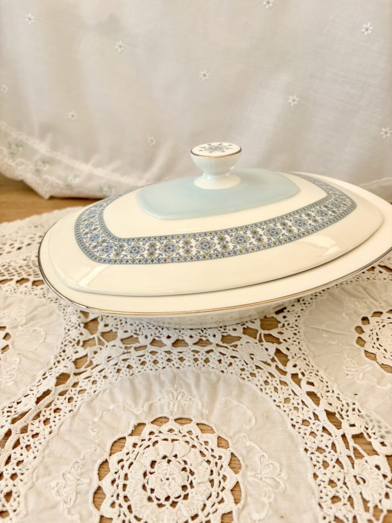 Decorative ceramic dish with lid on a lace tablecloth