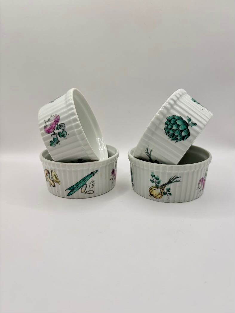 Set of four ceramic ramekins with botanical illustrations on a light gray background