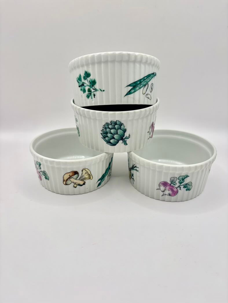 Set of four ceramic bowls with botanical designs on a white background