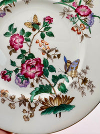 Decorative plate with floral and butterfly design on a white background