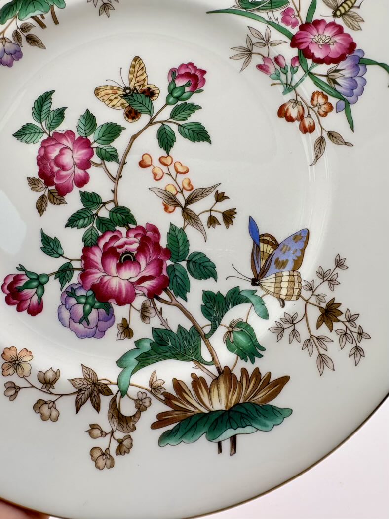 Decorative plate with floral and butterfly design on a white background