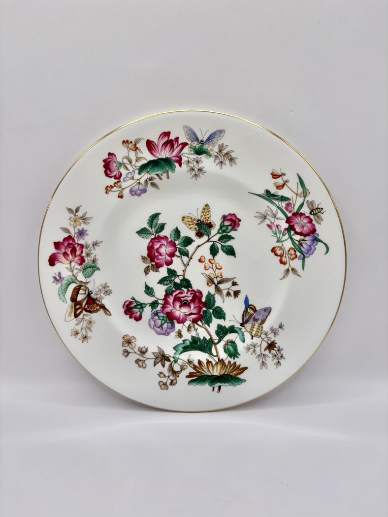 Decorative plate with floral and butterfly design on a plain background