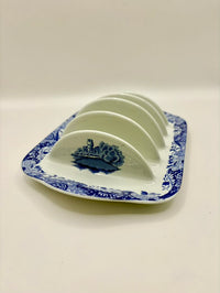 Blue and white ceramic plate with a decorative border on a white background