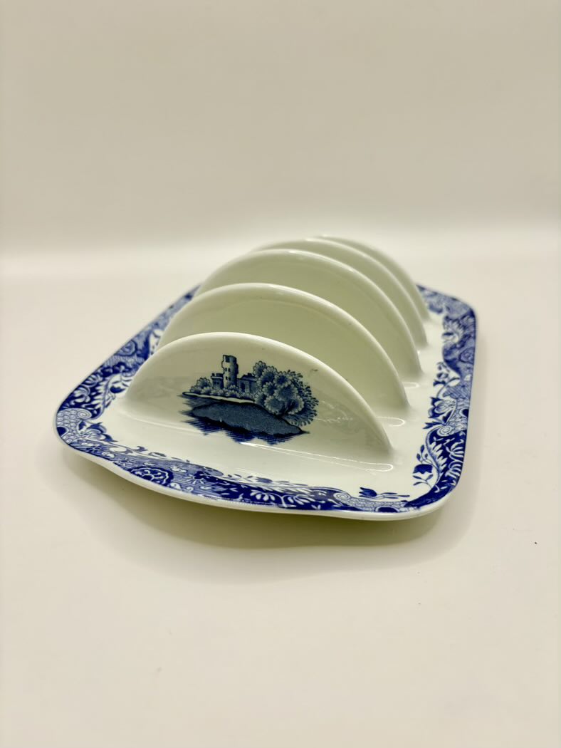 Blue and white ceramic plate with a decorative border on a white background
