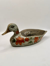Decorative duck-shaped object with floral patterns on a white background